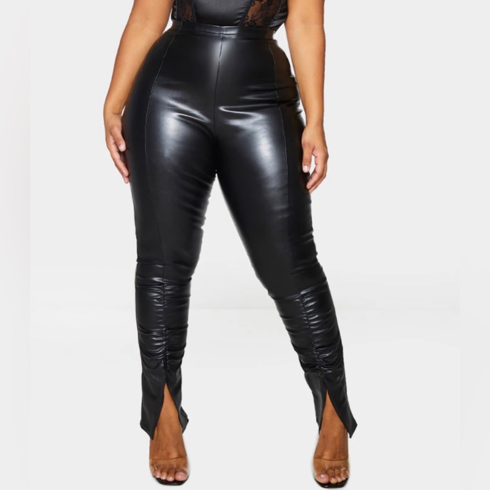 Black leather pants with front slit on the bottom of the pants